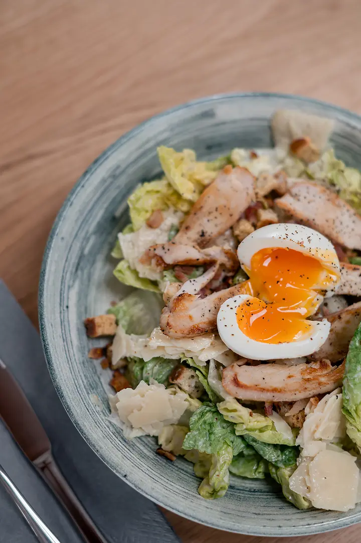 Chicken Caesar salad with a soft egg