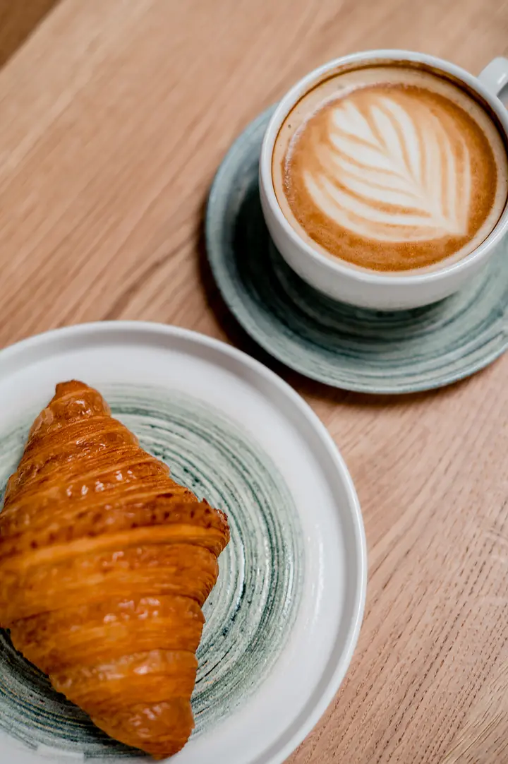 A croissant and a flat white