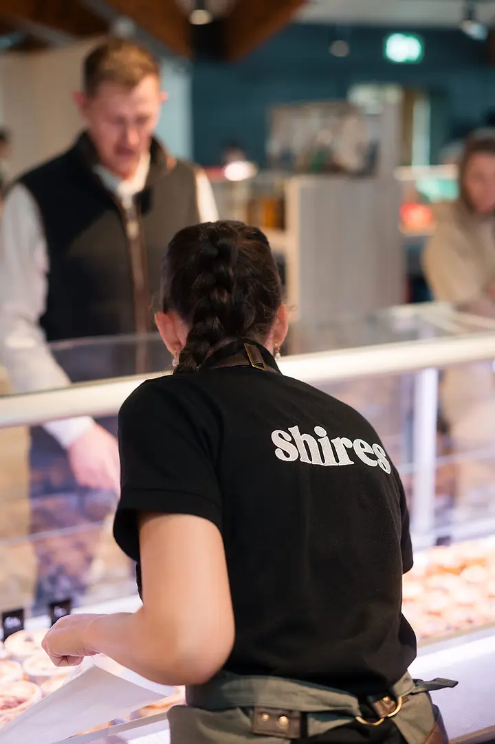 Serving a customer at the deli counter