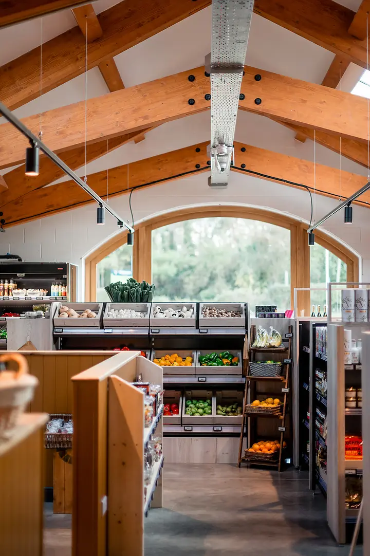 Inside the farm shop, looking along the aisles under the timber roof
